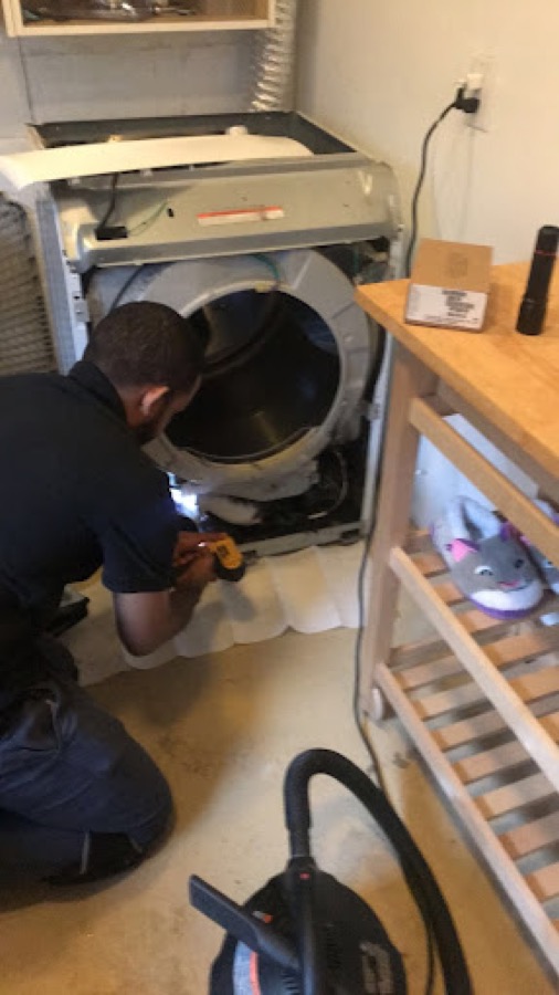 Technician diagnosing a dryer issue