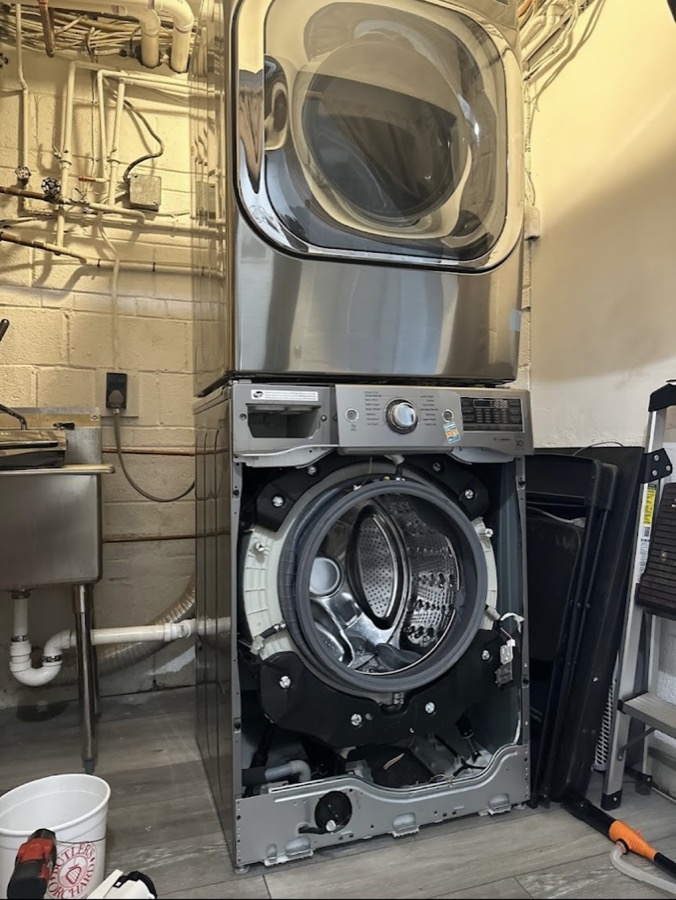 Stacked washer opened for repair